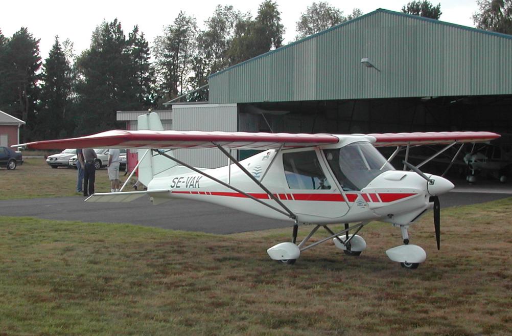 Light-sport aircraft parked near a hangar